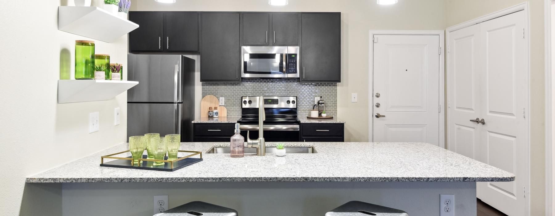 a kitchen with black cabinets