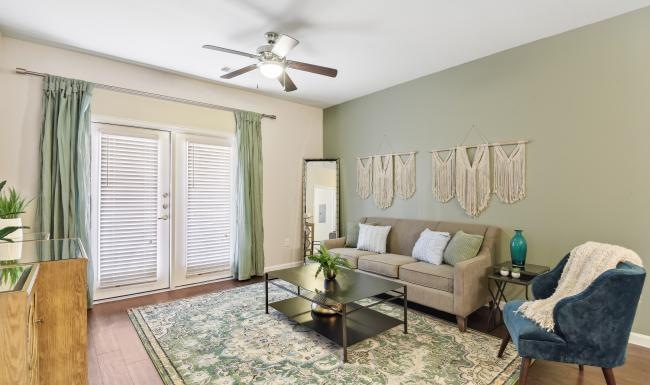 a living room with a fan and couches