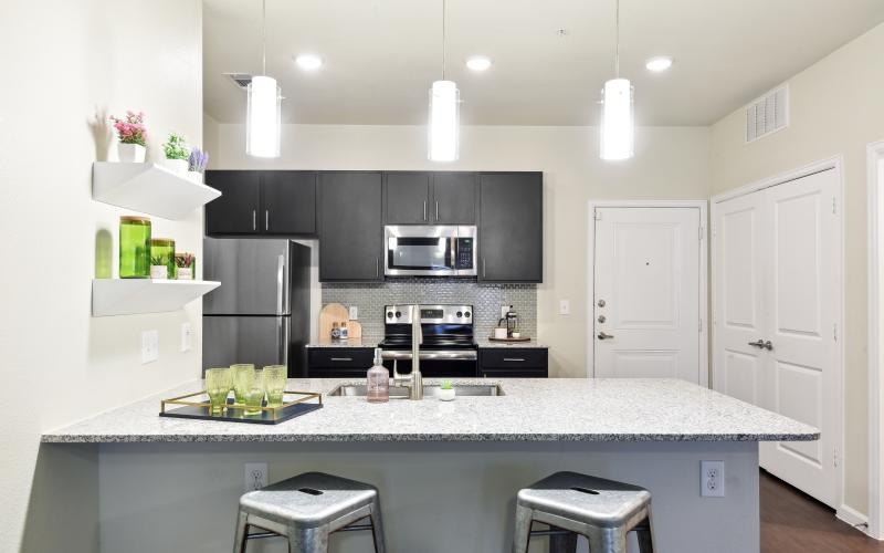 a kitchen with black cabinets