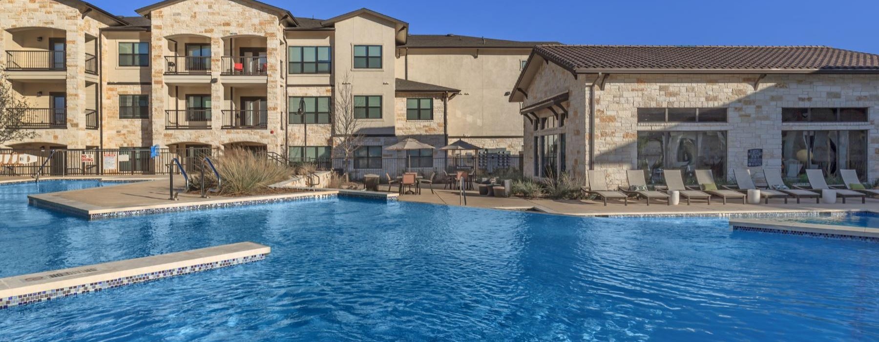a swimming pool in front of a large building