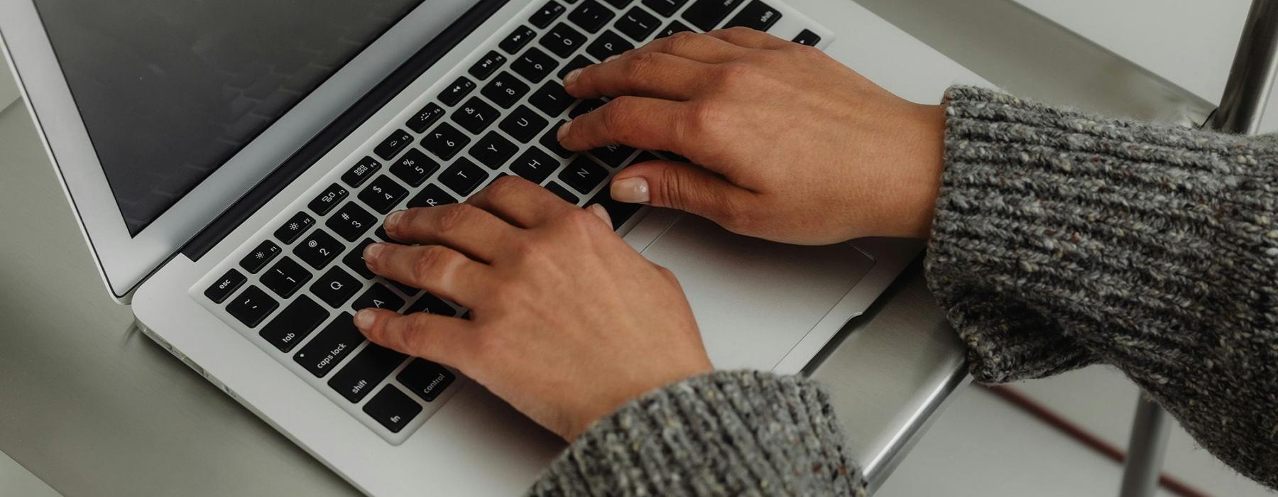 A person typing on a laptop
